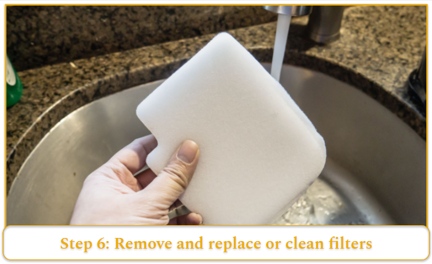 A foam vacuum clean filter about to be placed under a running faucet