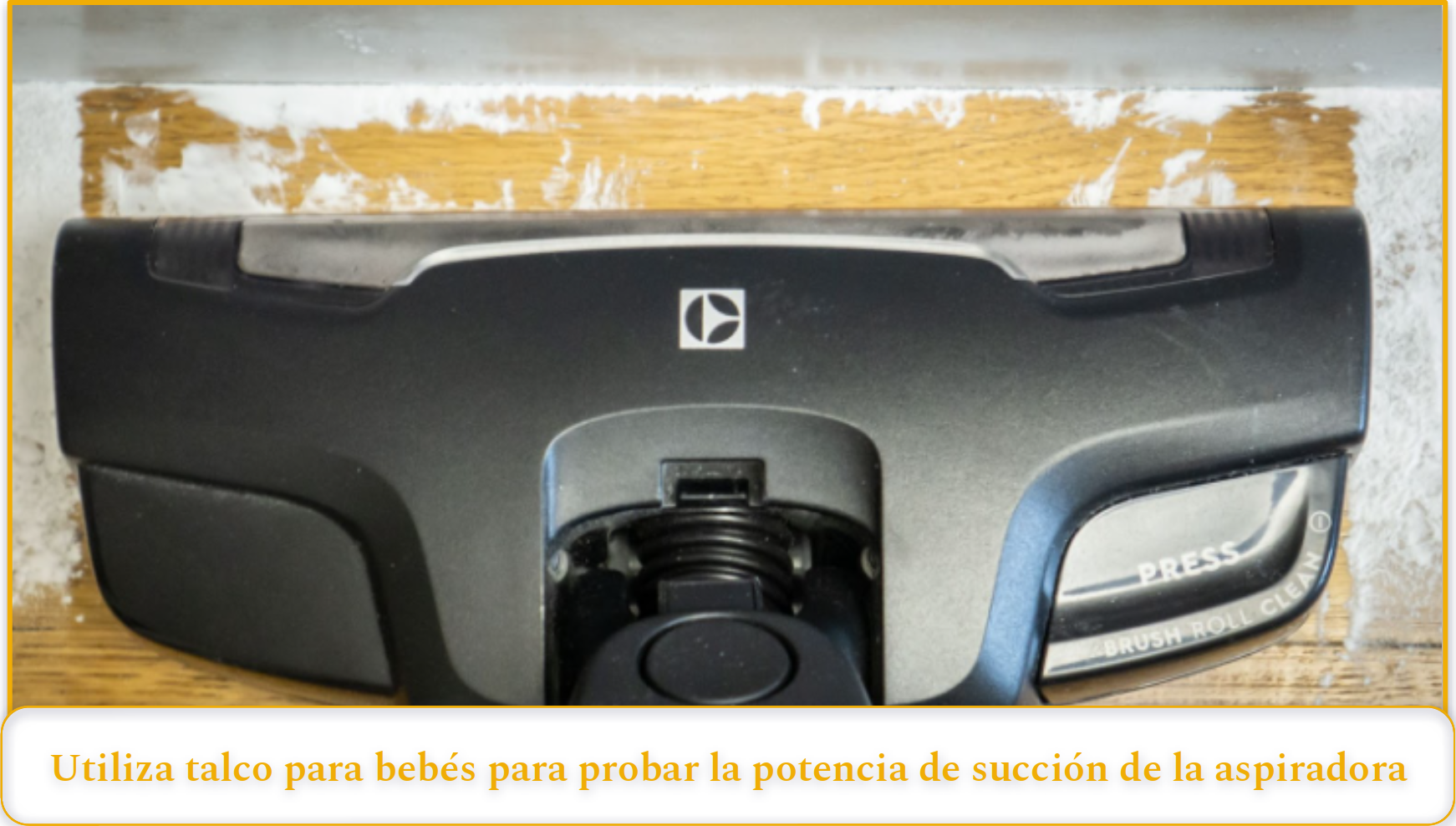 A vacuum brush head cleaning up baby powder on a hardwood floor