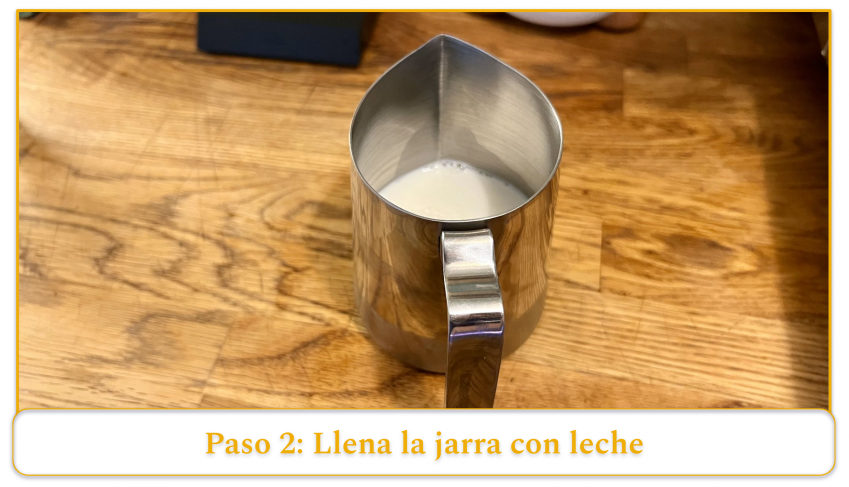 step 2 of using an espresso machine's steam wand; fill the pitcher with milk