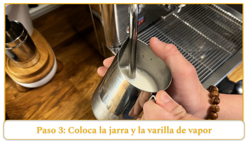 step 3 of using an espresso machine's steam wand; position the tip of the steam wand into the milk