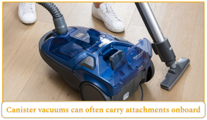 Blue canister vacuum with attachment storage.