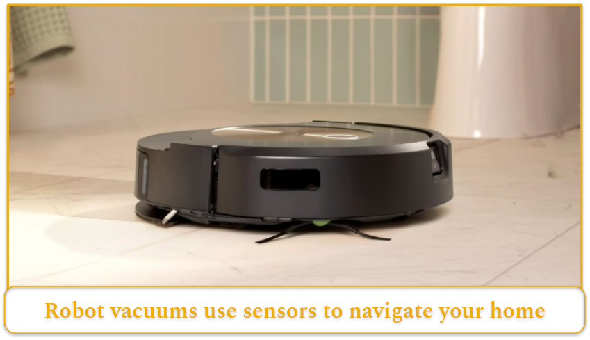 Black robot vacuum on tiled toilet floor.