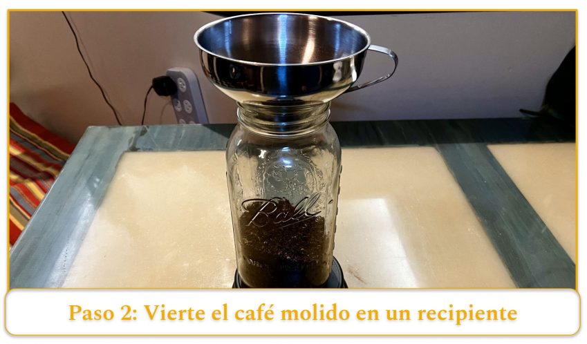 step 2 of making cold brew coffee; transferring coffee grounds into a glass mason jar